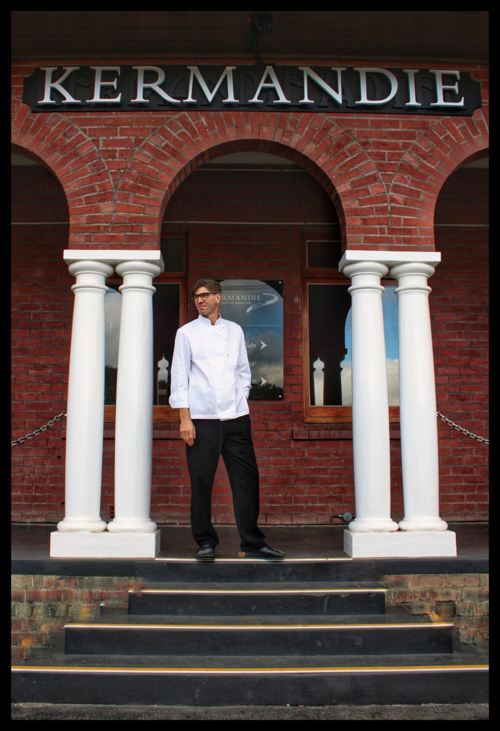 Chef David on some steps at the front of the Kermandie building in Port Huon